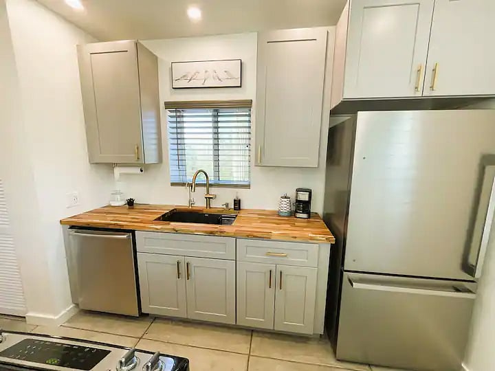 Galley style open concept kitchen. New cabinets, countertops, sink & appliances. Stone sink with Reverse osmosis drinking water, garbage disposal. Instant POU Rinnai hot water heater dedicated to this unit. 
