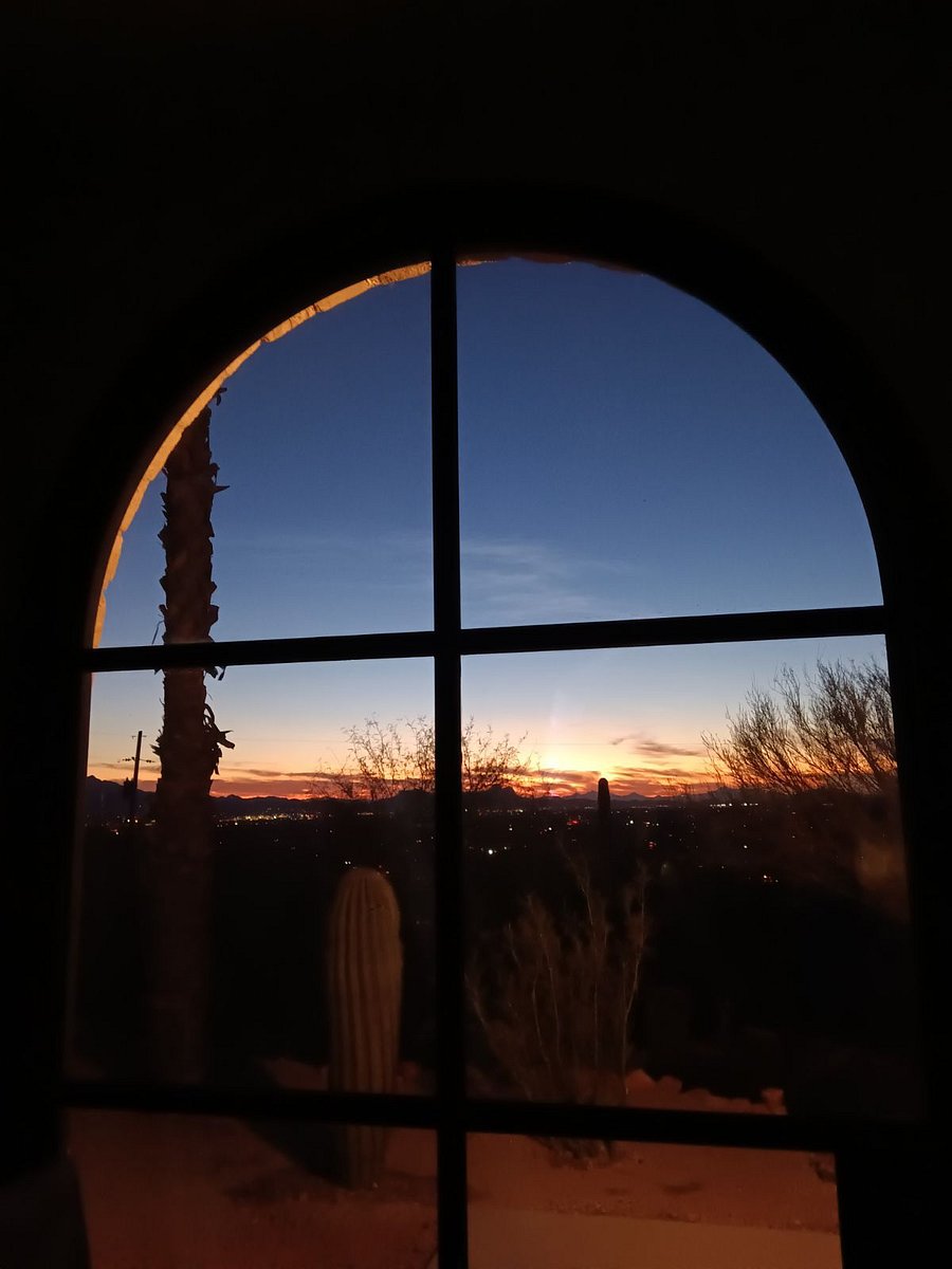 Evening interior city views from custom glass arched entry door,