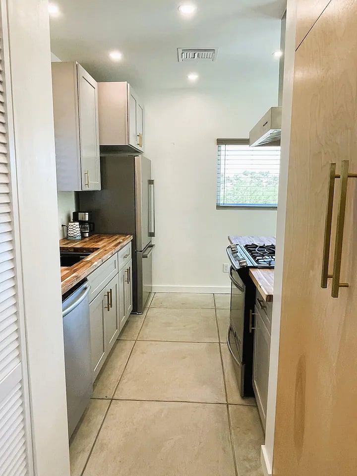 Galley style kitchen. Laundry is in the louvered closet door to the left. Pantry closet is to the right