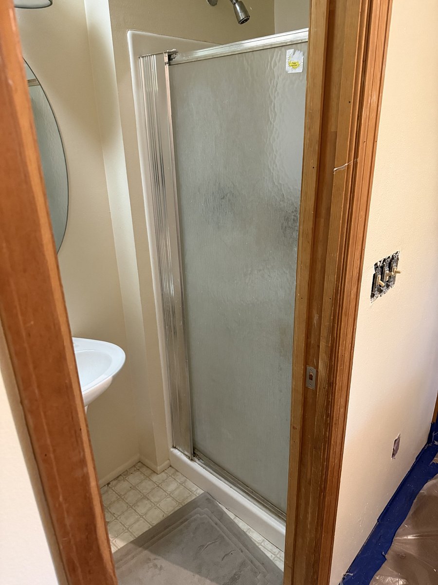 Small shower inside of the bathroom.