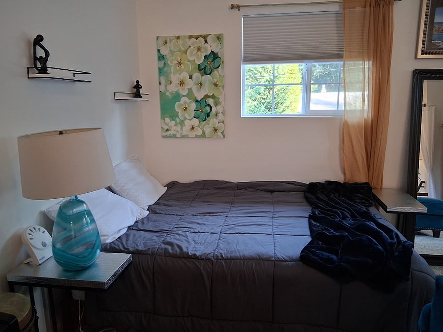 Queen bed with blackout blinds and curtains surtound for your comfort.