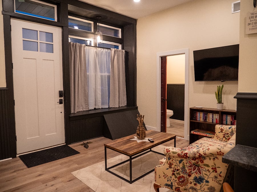 Living Room. Entrance Door, Full Bathroom, & Smart TV