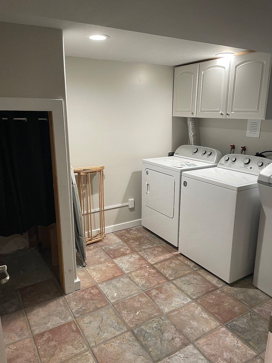 Laundry room with under the stairs storage