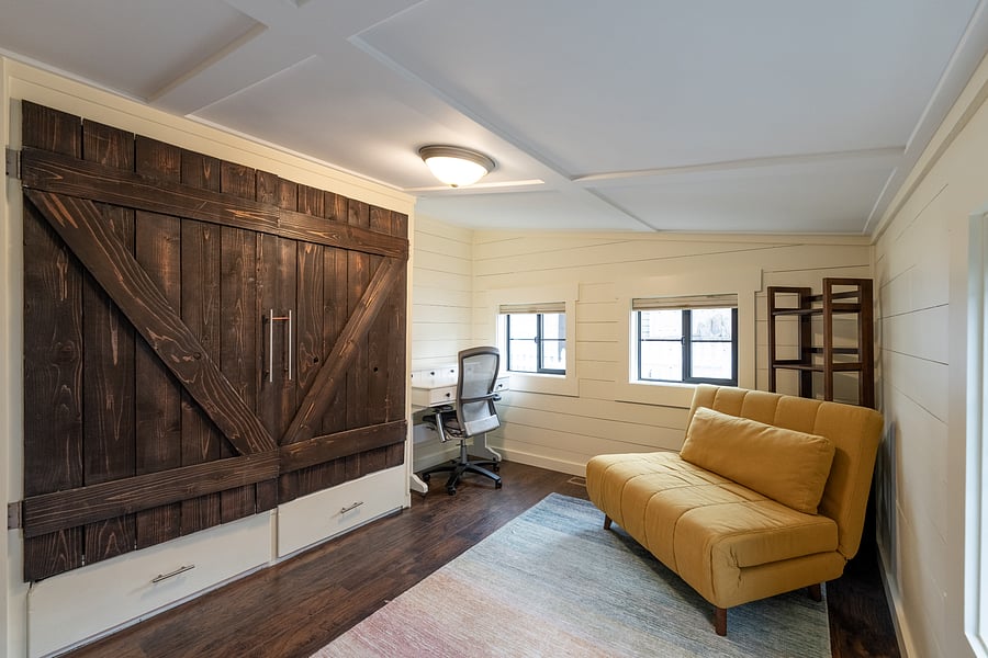 Cozy second bedroom with a full-size bed, built-in closet and custom blackout shades.
