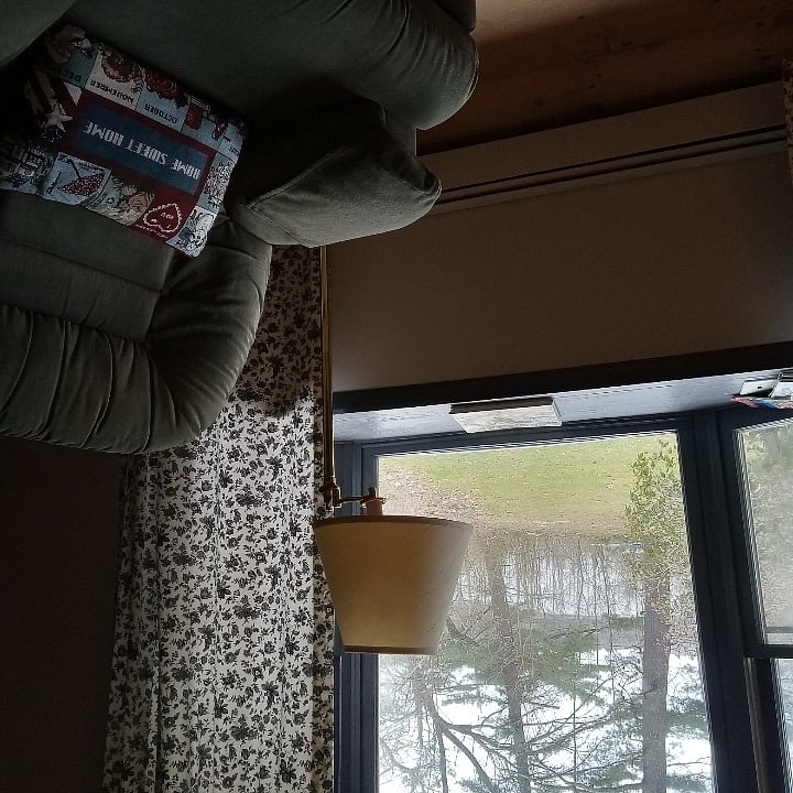 Nice view of water from livingroom chair next to fireplace.