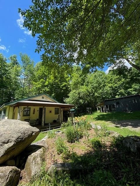 2 bedroom ranch, nice front and back yard, surrounded by trees, close to Cobbossee Stream.