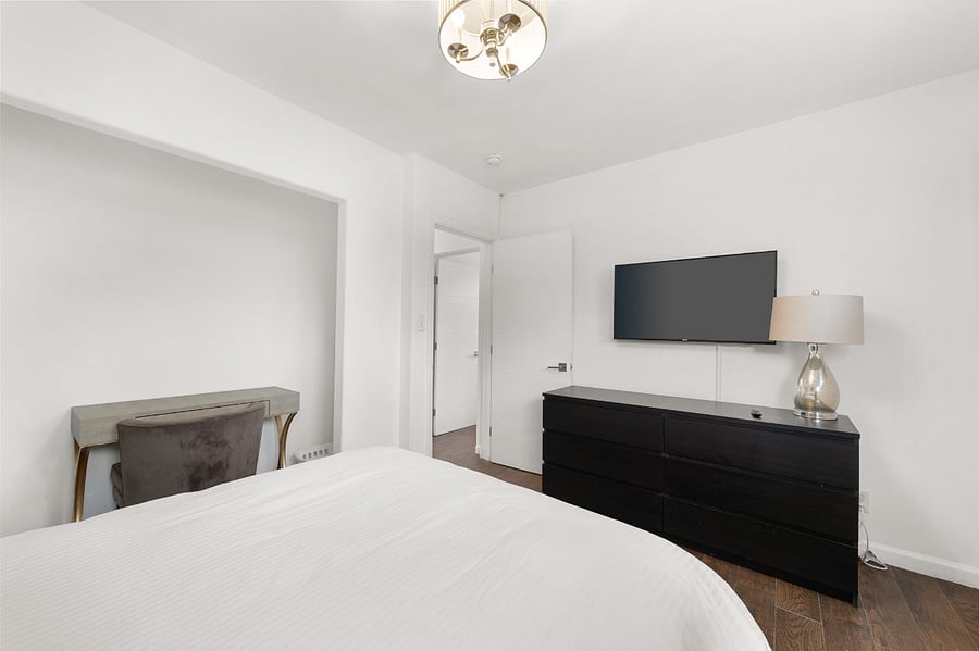 Second bedroom has a 42" Samsung smart TV, dresser, and desk. Closet area has a bar for hanging clothes (not pictured)