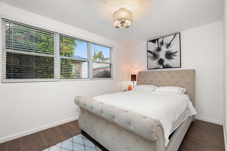 First bedroom with queen bed and memory foam mattress contains a window-mounted air conditioner (not pictured)
