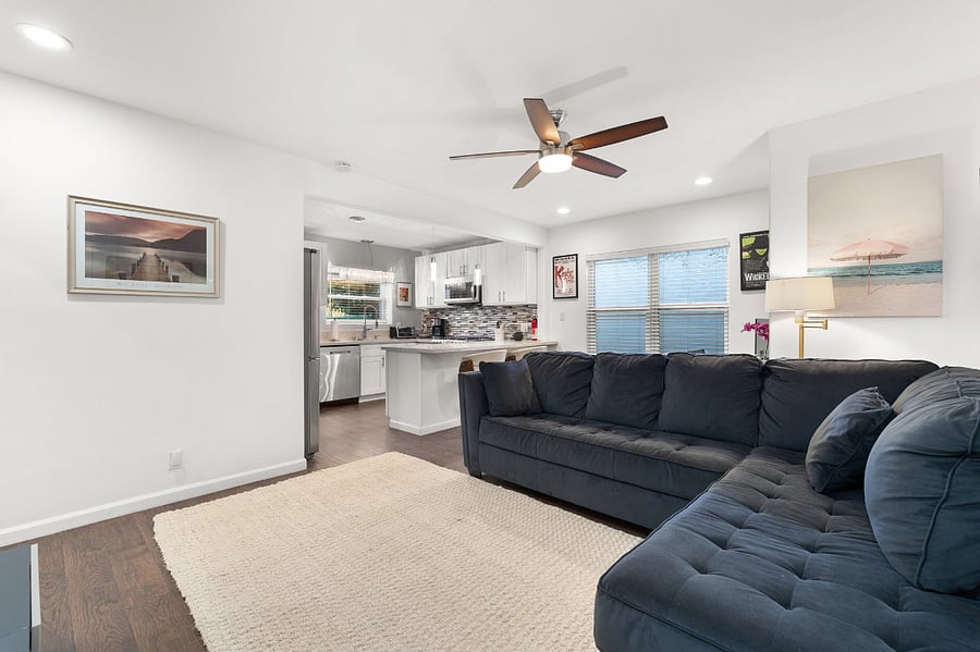 L-shaped sofa in the living room is great for stretching out under the cooling ceiling fan (window-mounted air conditioner not pictured)