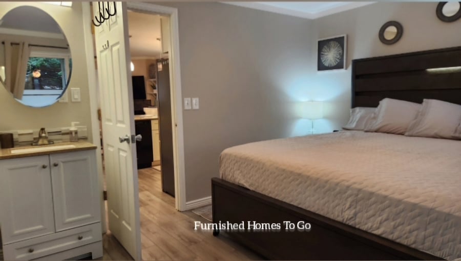 King bed with double decker closet rods for a massive amount of hanger space. Additional sink basin in bedroom for couples that need more space when getting ready.