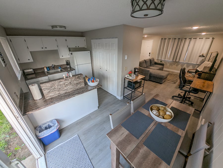 Dining area with 4 chairs adjacent to kitchen
