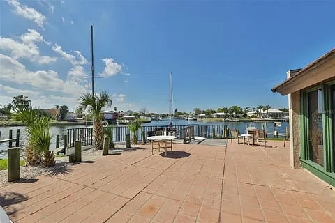 Deck outside the Condominium's Community Room, available to all residents and owners, where residents can enjoy watching a variety of boats passing and dolphins frolicking in the canal