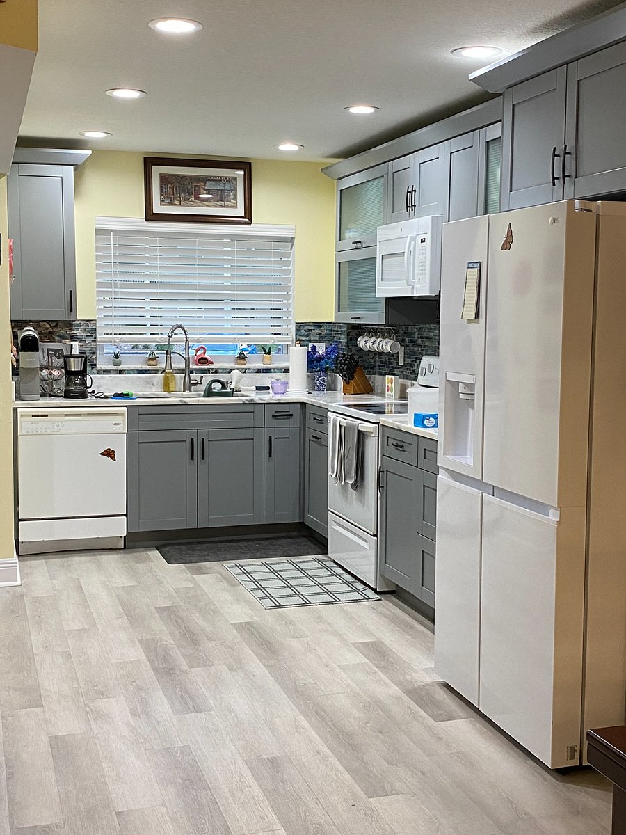 Kitchen with grey cabinets, marble countertops, double sink (garbage disposal) dishwasher, side by side refrigerator with exterior cold water and ice (2 styles) ice cubes.