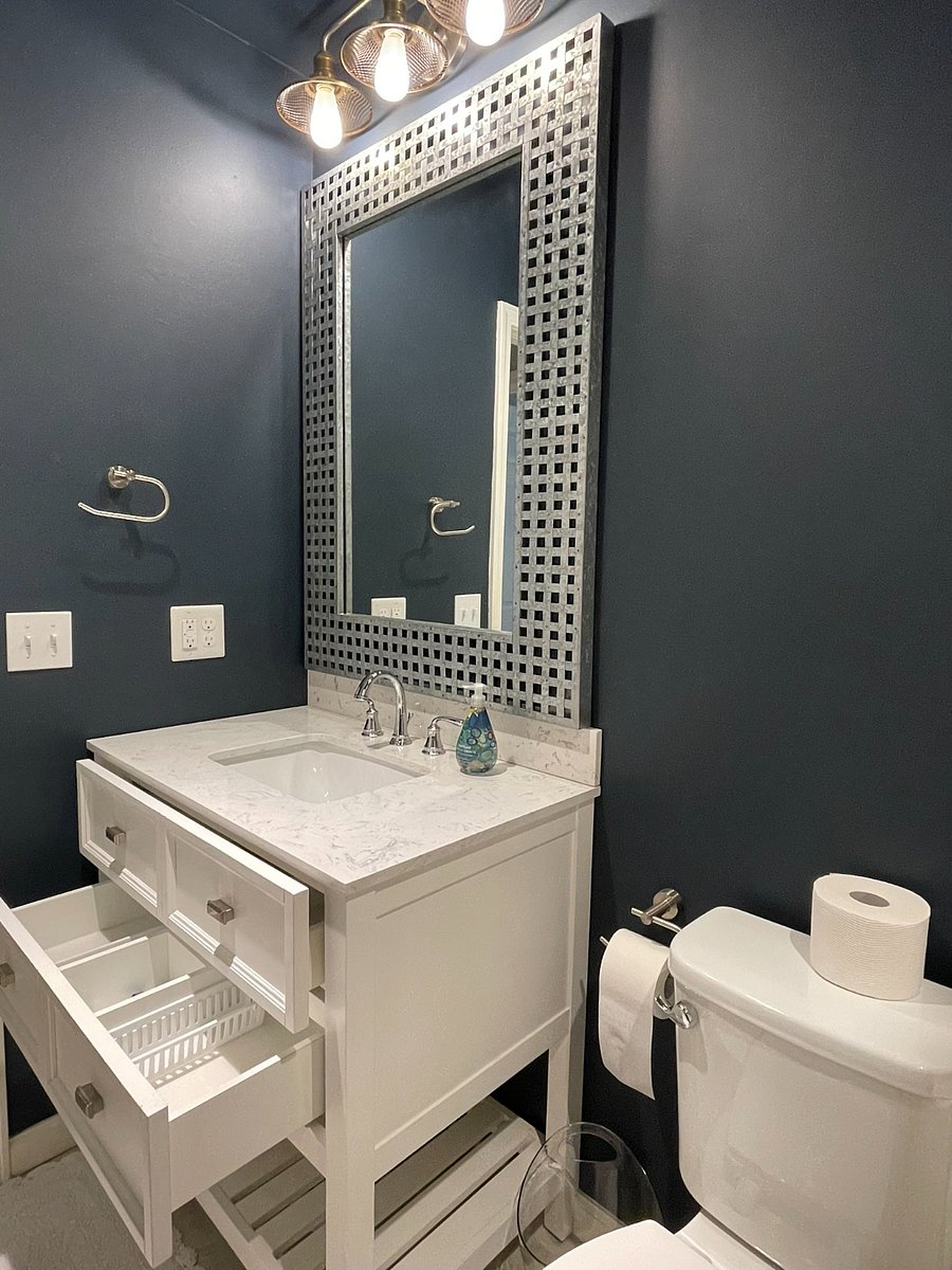 The Upstairs bathroom is a full shower tub combo. It includes a quartz counter at the sink and drawers for bathroom storage