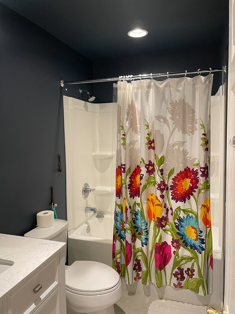 The Upstairs bathroom is a full shower tub combo. It includes a quartz counter at the sink and drawers for bathroom storage