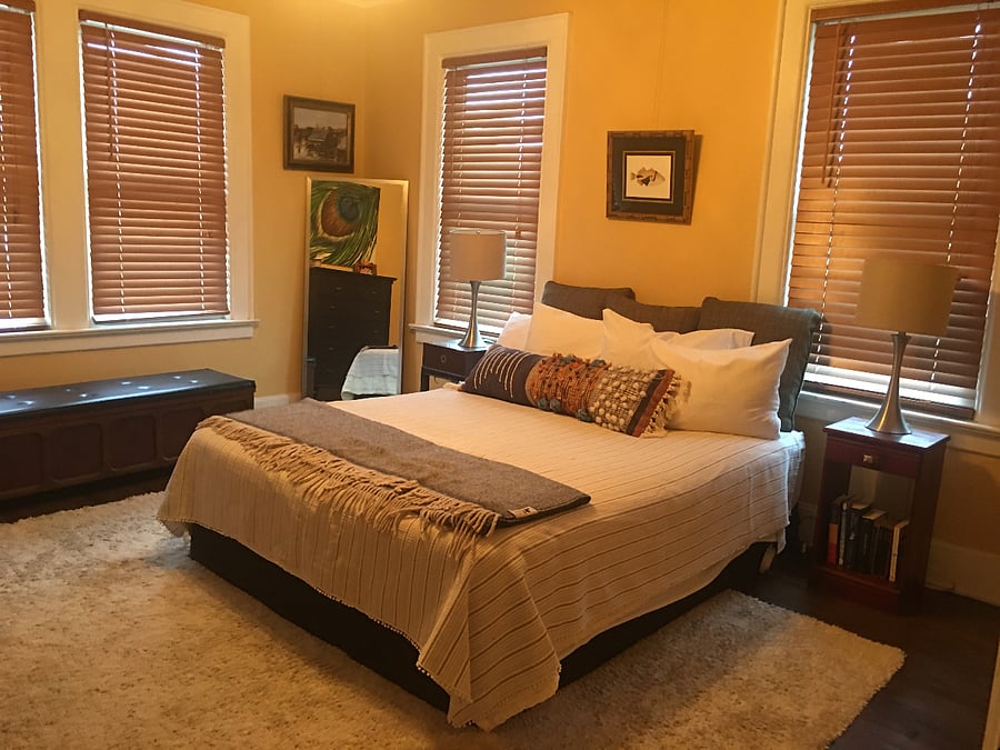 Large Sunny Bedroom with Streetside views has a Savannah-Bombay feel.