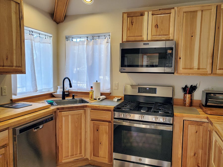 Fully functional kitchen with forest themed, environmentally sound butcher block counter