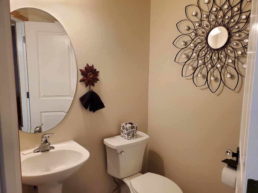 Half bath in hallway from living room across from new model washer/dryer.