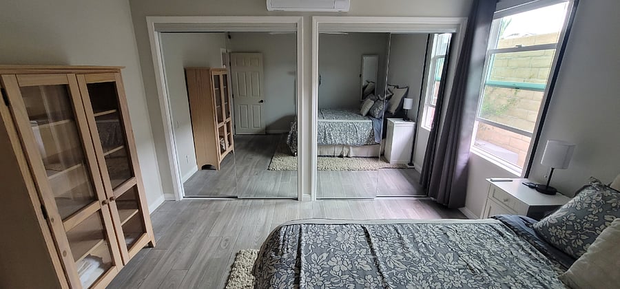 Bedroom reflected in mirrored closet doors...+A/C mini-split