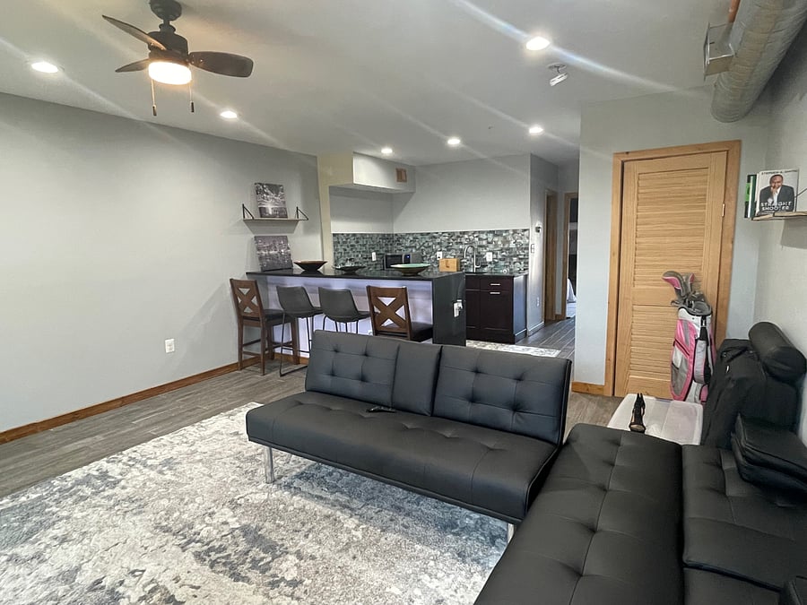 Living room features two leather futons for you to lounge on as you watch tv, read, enjoy the fireplace or just rest.