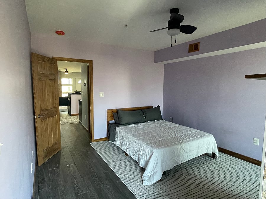 The bedroom includes a wood burning fireplace, wall-mounted tv and private balcony.