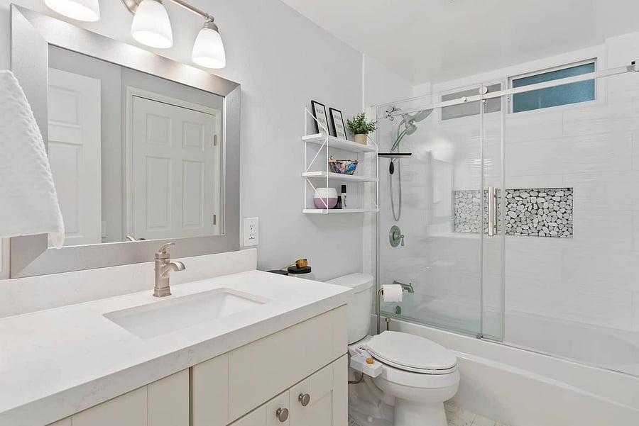 Refresh in the bright, modern bathroom featuring a spacious walk-in shower and rainfall showerhead.