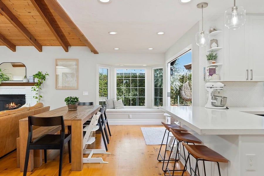 Gather around the large dining table with convenient high-chair seating, bar stools, and an open connection to the kitchen.