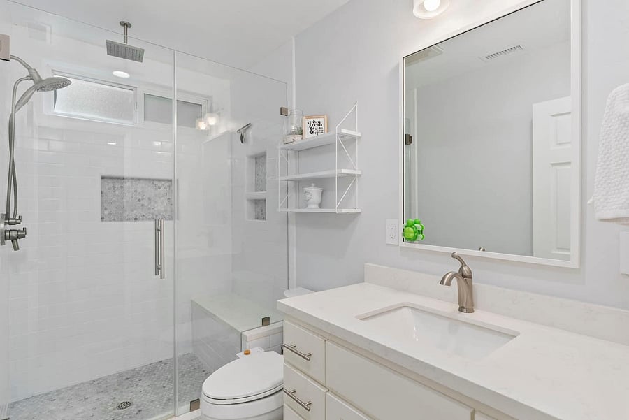 Enjoy a refreshing shower or bath in this bright and modern bathroom with a spacious vanity and glass-enclosed tub.