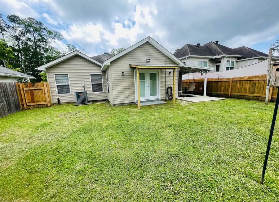 View of the backyard from standing at the back fence, looking at the house.
