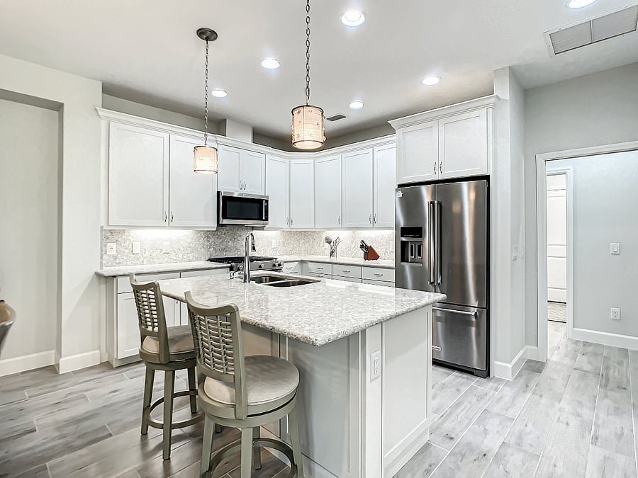 Kitchen with seating for two at the island. Under cabinet lighting.