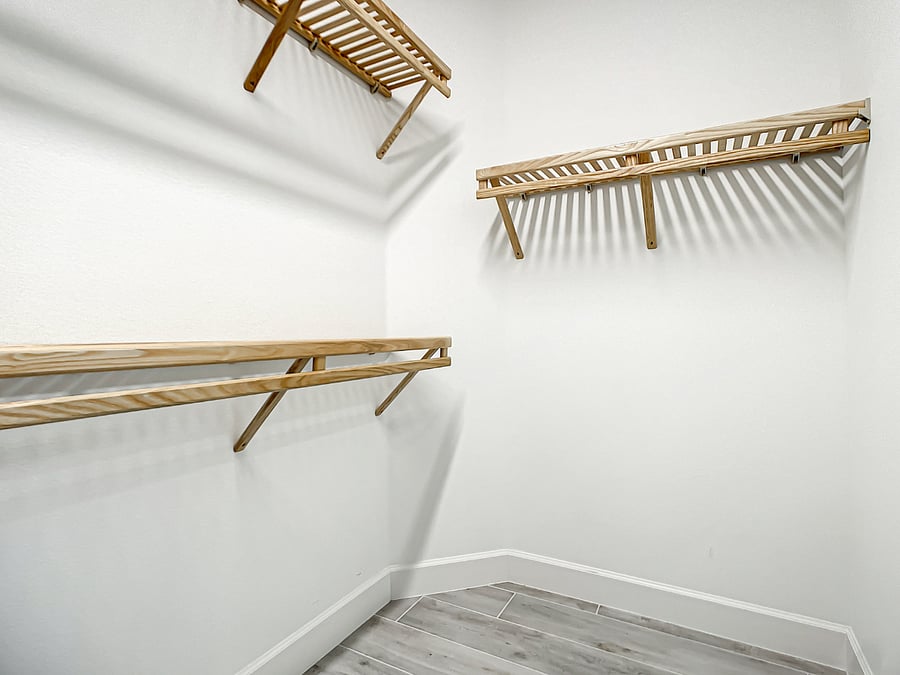 Owner's Suite walk-in closet with wood shelving. This style of wood shelving is an upgrade throughout the house.