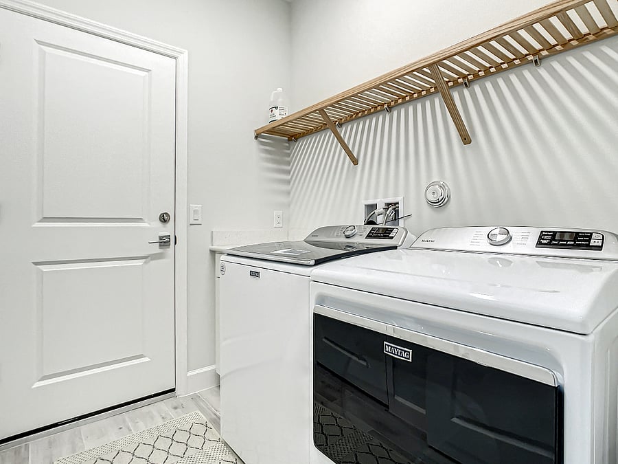 Maytag clothes washer and dryer. Door leads to two-car garage.
