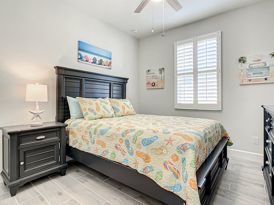 Guest bedroom with matching headboard, night stand, and dresser.