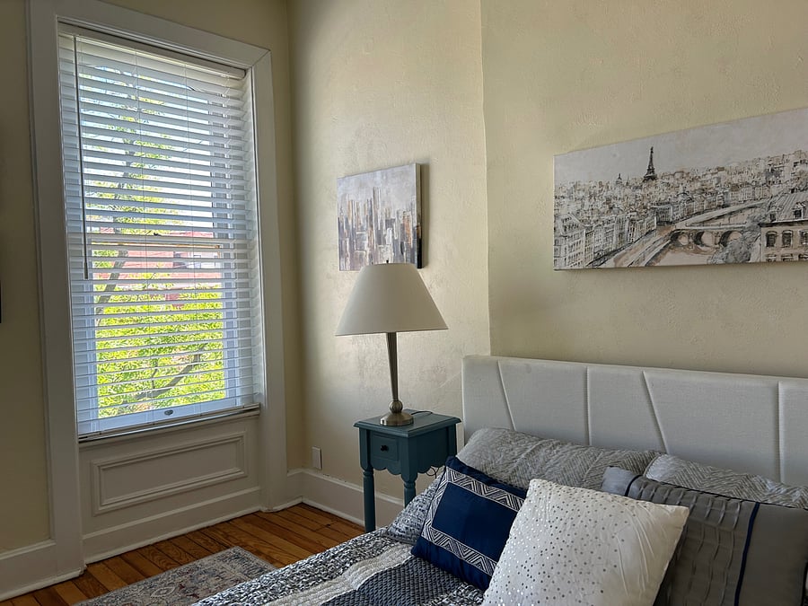Bedroom with custom blinds for privacy and quiet and new queen with luxurious bedding
