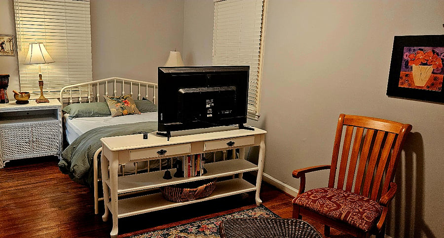 Master bedroom with sitting area and Smart TV