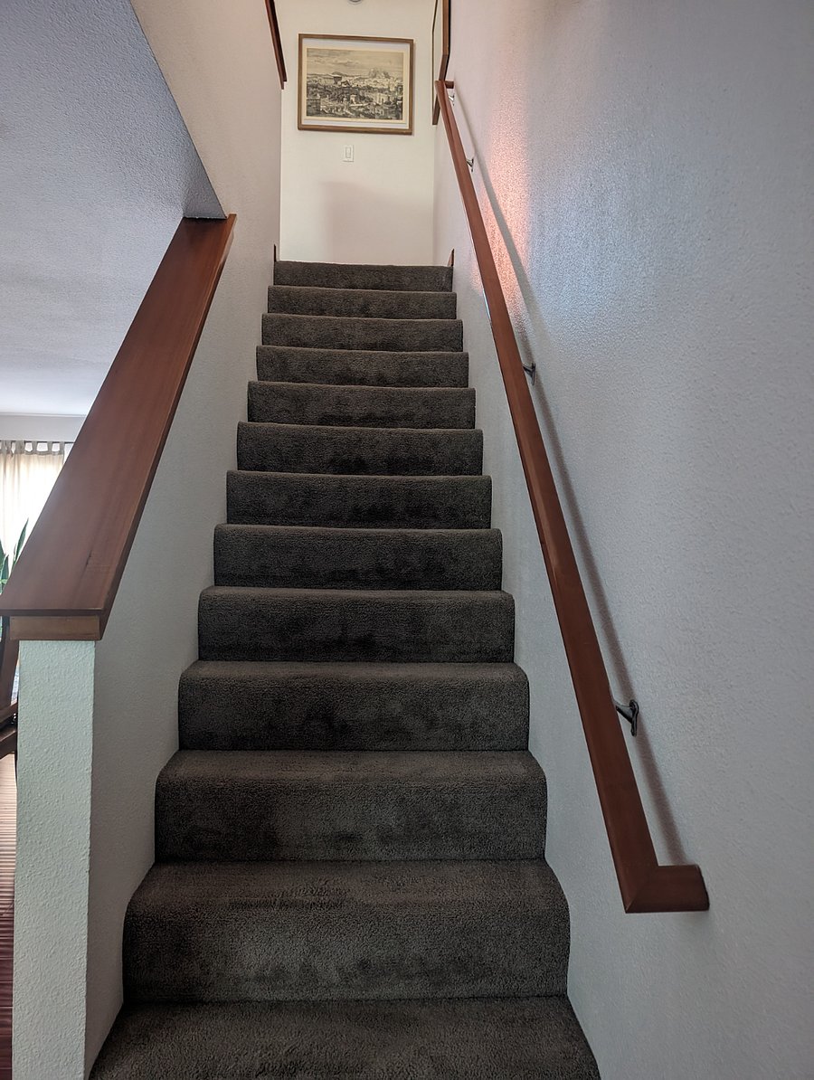 Stairs that lead to bedrooms and bathroom. 