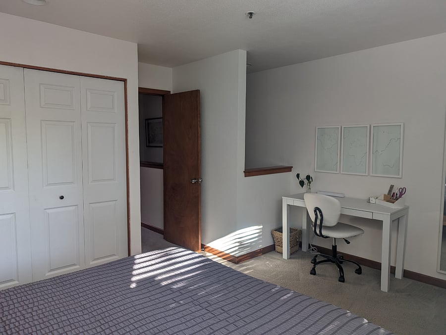 Large bedroom with a king bed and working desk