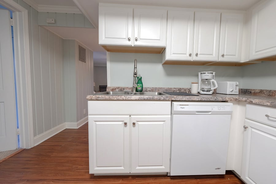 Spacious kitchen includes dishwasher, coffee pot, toaster, and kitchen supplies