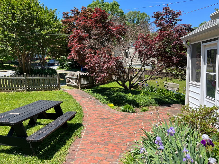 Circular gravel drive provides one parking space and pathway to entrance