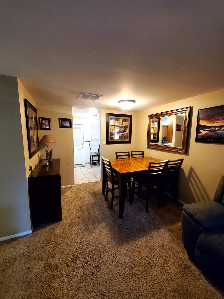 Dining Room inside Living Room with large wood table outside kitchen area.