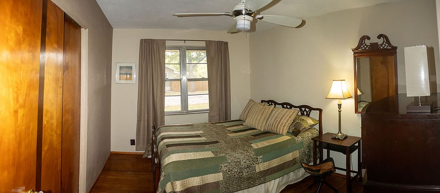 First bedroom on right, in hallway. Full sized bed. 