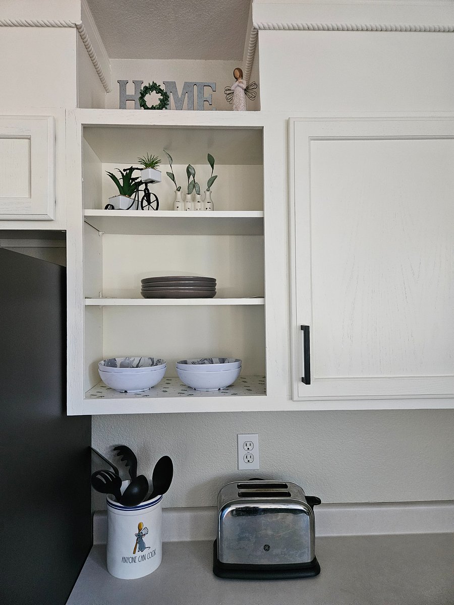 Fully stocked kitchen with dishes, utensils and cookware