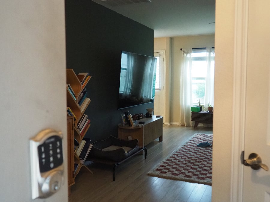 Front door entrance leading you into the living room with a half bathroom immediately to the right.