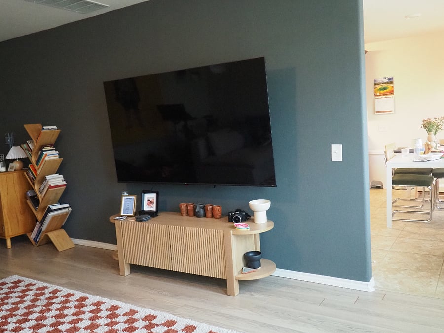 Living room wraps around to the kitchen and additional family room space. Living room equip with a 72" TV.