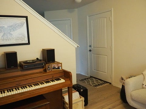 The 2nd family living space on the main floor leads back to the garage (door shown in photo) and stairs leading up to the bedrooms and full bathrooms.