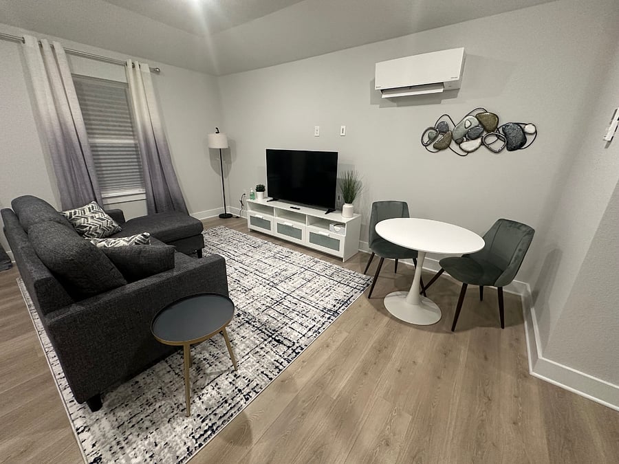 Comfortable couch with chaise for lounging, a 52 smart TV, and another split unit to quickly heat/cool the space. Dont underestimate this unit, its small but mighty!
