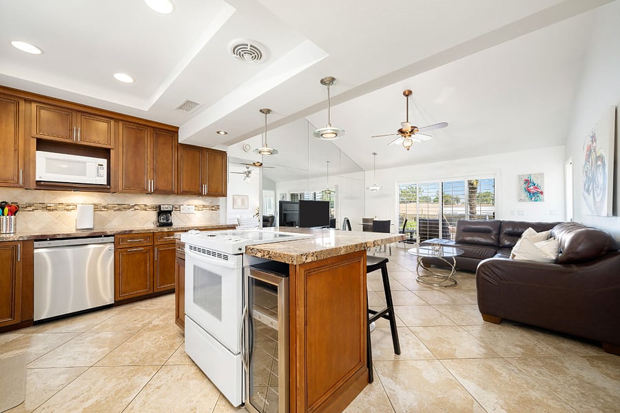 Kitchen opens to living room with lots of natural light