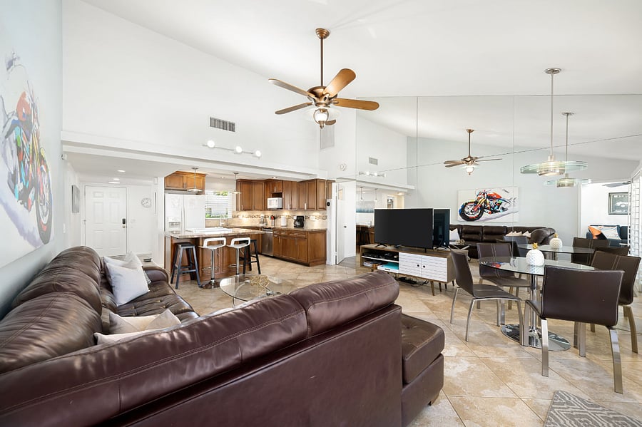 Large, open living room with tall vaulted ceilings and natural light