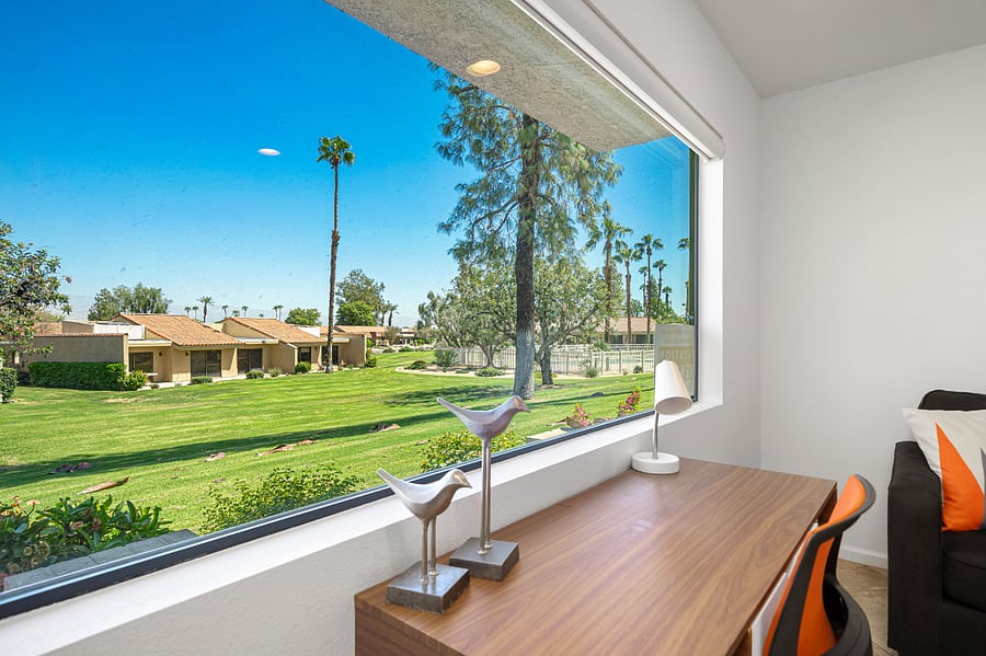 Enjoy views of the mountains and pool while working at the desk