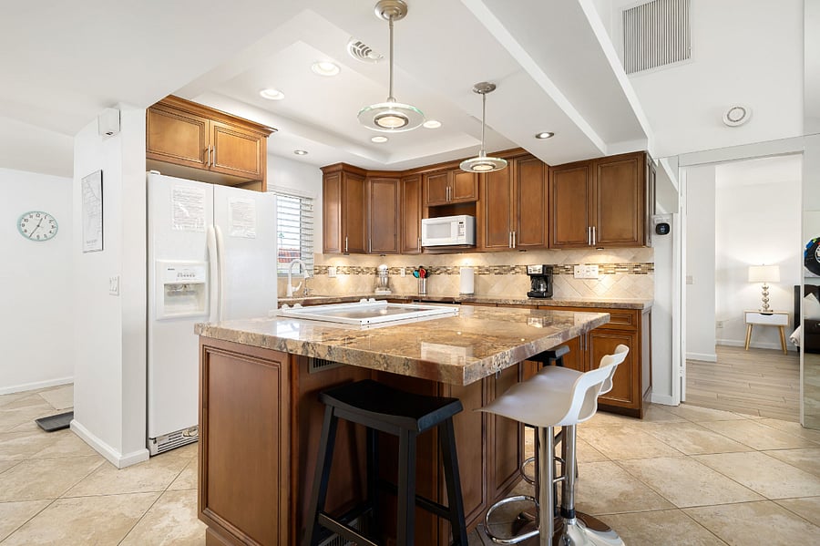Open floor plan kitchen with island seating for 4